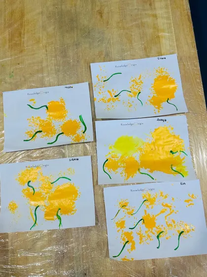 Here are the beautiful results of our flower painting session. Each piece is a unique creation, showcasing the different ways the children explored the materials.
