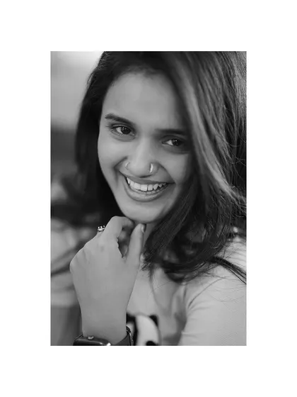 A candid, black and white portrait that captures a genuine, happy smile. This kind of shot is all about capturing personality in its most natural form.