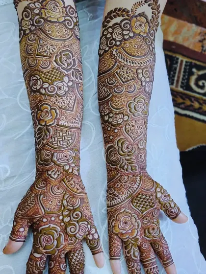 Another shot of this rose and geometry-themed bridal mehndi, showing the full arm coverage.