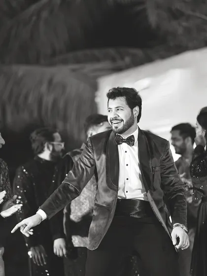 The same moment captured in classic black and white, highlighting the joy and energy of a wedding celebration.