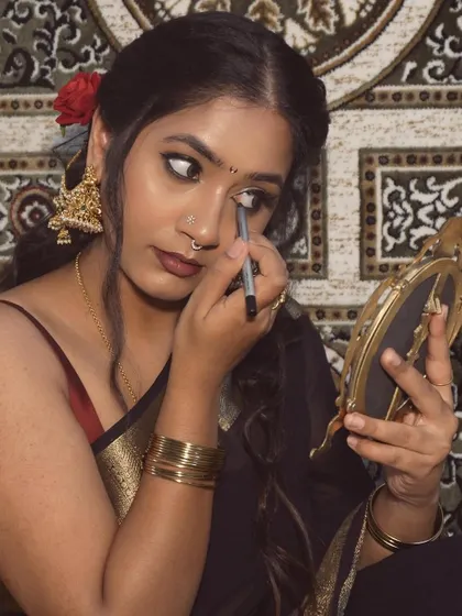 An aesthetic shot of me getting ready. I love the entire process of doing my makeup, wearing a beautiful saree, and putting on my jewelry. It's a form of self love.
