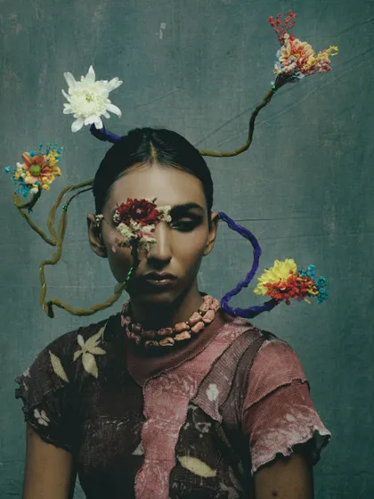 A look from the "Concrete Woes" series, which explores our relationship with nature. This avant-garde makeup uses floral elements to create a piece of living art.