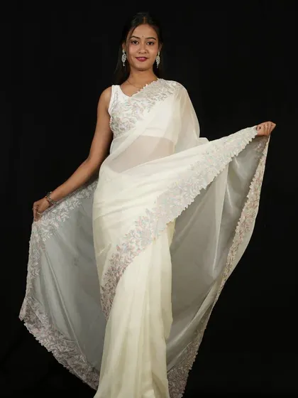 This ethereal white organza saree is part of my 1-Minute collection. It features delicate silver embroidery along the border, offering a graceful and angelic look for special occasions.