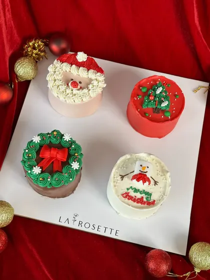A collection of our adorable Christmas-themed Bento cakes, featuring Santa, a Christmas tree, a wreath, and a snowman.
