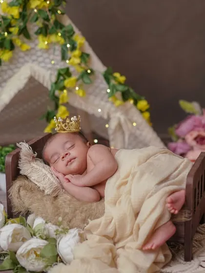Love at first sight. This magical teepee setup, with its warm lights and floral accents, is the perfect backdrop for a sleeping prince or princess.