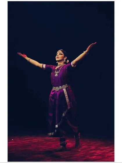 A powerful pose from Sandhya Udupa, her arms outstretched in a gesture of offering.