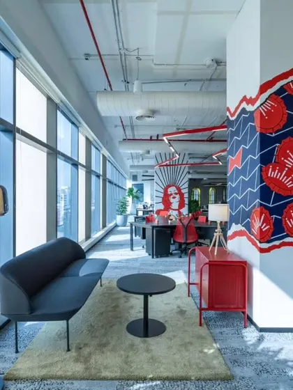 We painted columns throughout the AbInbev office with custom designs inspired by their beer labels. This one features a bold red and blue pattern, turning a structural element into a piece of art that energizes the open-plan workspace.