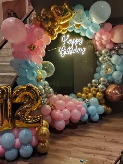 A fun and colorful balloon ring for a 12th birthday, using a mix of pink, blue, gold, and silver balloons.