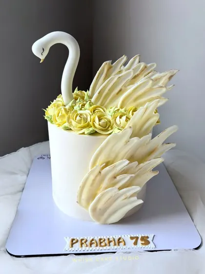 A graceful swan cake for the special woman in your life. This design features a beautiful swan with wings made of white chocolate and delicate buttercream roses.