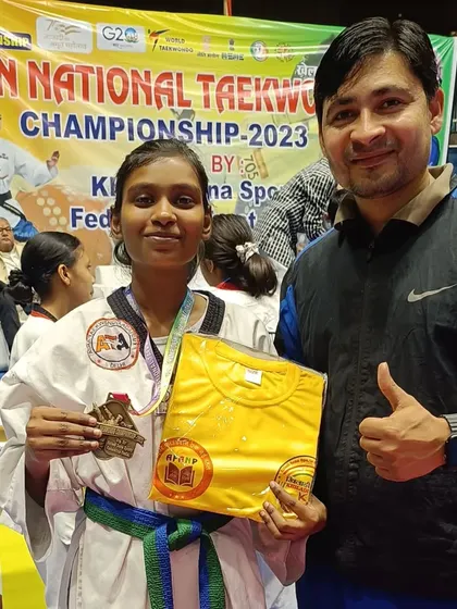 A student with her bronze medal and a prize t-shirt. Every achievement is celebrated.
