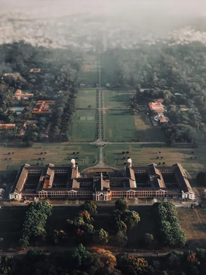 The beauty of architecture is often in its symmetry, something you can only truly appreciate from above. This top-down drone shot captures the incredible scale and design of this building surrounded by nature.