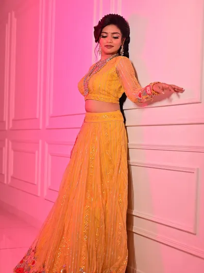 A full-length portrait where the makeup enhances the model's confident pose. The look is bold enough to match the vibrant outfit but refined enough to maintain a sense of elegance.
