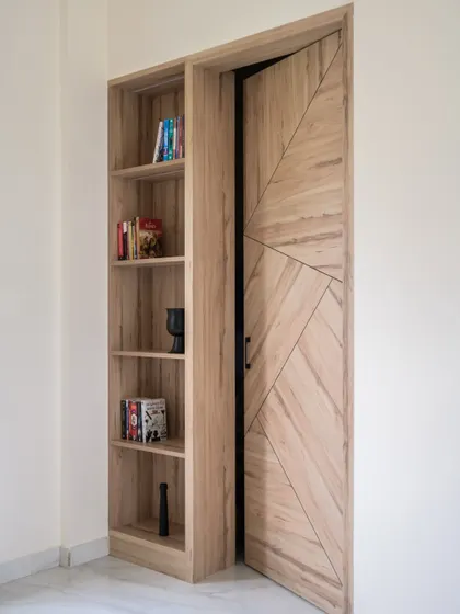 The hidden door is shown here slightly ajar, revealing the entrance. This technique is great for creating private zones or hiding service areas while maintaining a clean, uninterrupted wall design.
