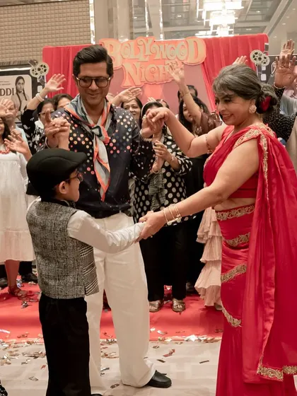 Three generations on the dance floor, enjoying the retro music and festive atmosphere.