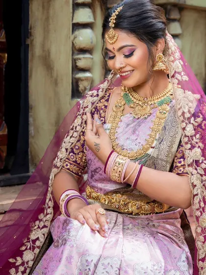 A beautiful candid moment, showing the intricate details of the saree and the sheer dupatta.