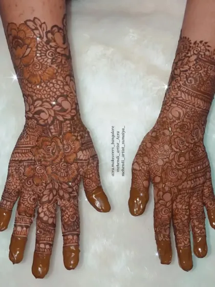 A full-hand non-bridal mehendi design with intricate floral and paisley patterns.