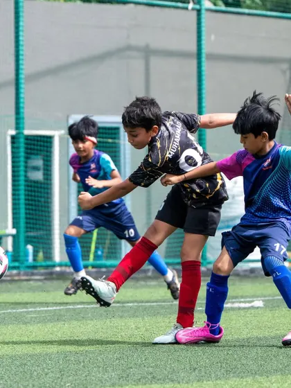 A U11 player in action during a thrilling match at the Pro Super League. These competitive games are vital for development.