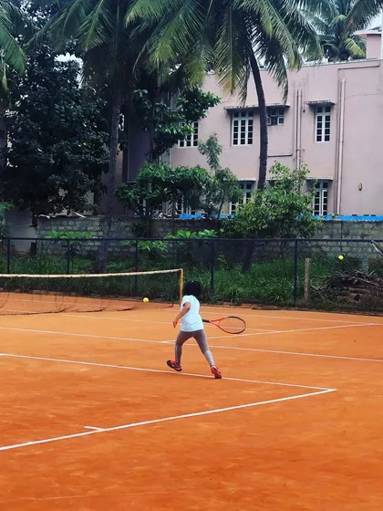 Two junior girls rally during a competitive match at the Tennis360 Academy tournament.