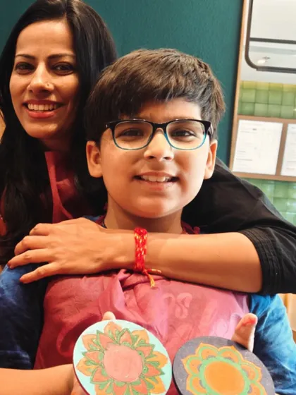 A proud mother with her son, Shaurya, and the coasters he painted. A perfect mother-son creative date.