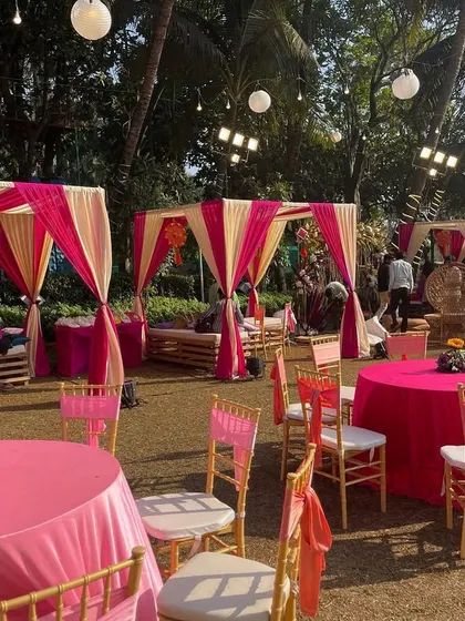 A charming Mehendi setup with pink and cream cabanas and matching table decor. This creates cozy and stylish seating areas for guests to relax and mingle.