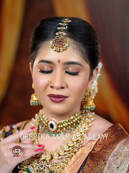 A close-up shot with the bride's eyes closed, giving a clear view of the soft brown and gold eyeshadow work. The makeup is subtle yet impactful.