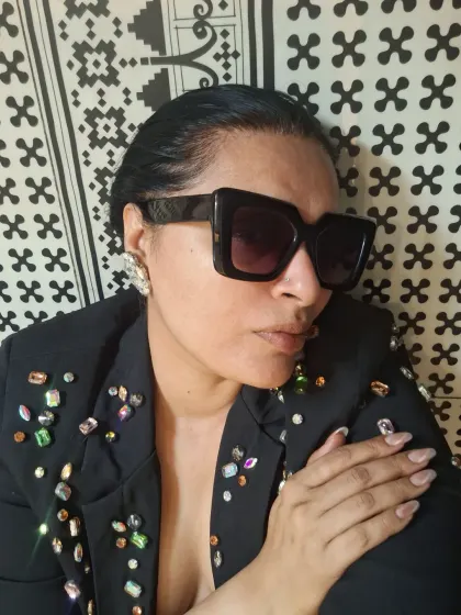 All about the attitude. A close-up shot featuring a jeweled blazer and bold sunglasses, showing that sometimes the details are the entire story.