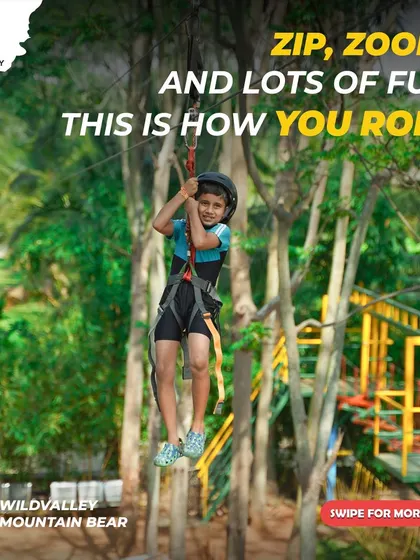 Even our youngest adventurers can get in on the action. Here, a child safely enjoys a zipline ride, fully harnessed and supervised by our trained staff at the Mountain Bear resort.