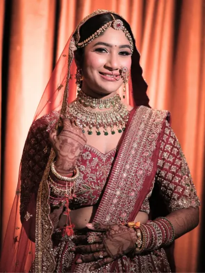 A happy, smiling portrait of the bride. Her makeup is designed to enhance her joy, with a radiant finish and defined eyes that sparkle.