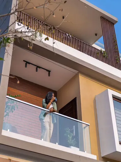 A slightly different angle of the Sarjapur residence, highlighting the clean lines and the relationship between the solid walls and open balconies.