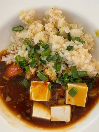 A comforting bowl of Mapo Tofu with sticky rice, served as one of the main courses. Plated individually, each dish is given the care and attention it deserves.