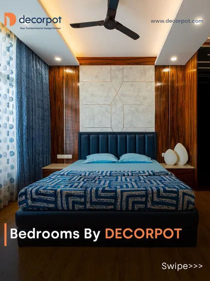 A bold and modern bedroom featuring a dark blue upholstered headboard set against a backdrop of rich wood and textured grey panels.