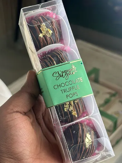 A close up of the chocolate truffle pops from our jungle themed hamper, decorated with a touch of gold leaf for an elegant finish.