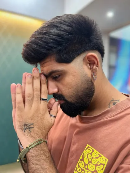 A complete look featuring the modern mullet with a perfectly groomed beard. The combination creates a powerful, contemporary style statement.