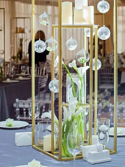 A modern centerpiece with calla lilies and floating candles. The clean lines and minimalist design of this decor complement the contemporary aesthetic of our indoor spaces perfectly.