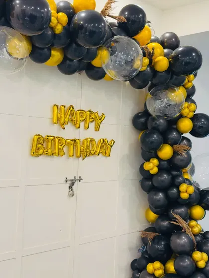 Another angle of the stylish black, gold, and confetti balloon arch. I use high-quality balloons and creative arrangements to make any entrance feel grand.