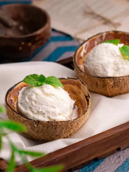 Another perspective of our coconut ice cream, capturing the creamy texture and fresh mint garnish. This shot feels cool, refreshing, and perfect for summer.