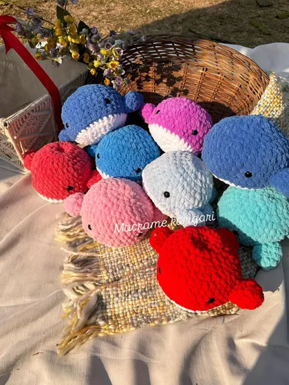 A basket full of our colorful handmade whales. Seeing them all together shows the beautiful variety we can create. These are great for baby shower gifts or nursery decorations.