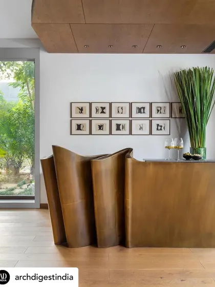 The iconic 'Tango Bar' in the K Residence, as featured in Architectural Digest. This sculptural brass piece is the protagonist of the casual lounge, serving as a functional and artistic hub for entertaining.