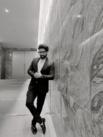 A black and white shot that captures the mood. Leaning against a marble wall, it's about bringing a cool, composed vibe.