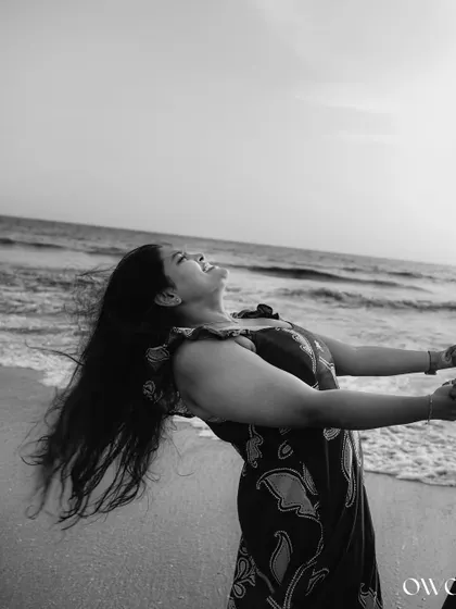 The pure joy of a moment captured on the beach. This black and white pre-wedding photo emphasizes emotion and movement against the timeless backdrop of the sea.
