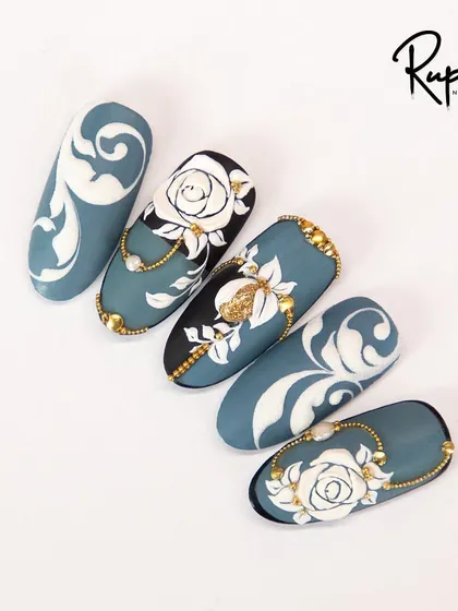 A top-down view of the baroque and 3D rose design, showing the beautiful contrast between the matte blue, glossy black, and sparkling gold.