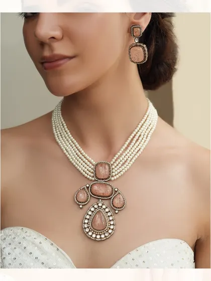 A unique necklace featuring a pendant with large, soft pink stones, perfect for a romantic look.