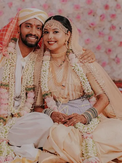 A happy couple portrait from a Coorgi wedding. The bride is wearing a traditional cream-colored saree, and her makeup is soft and natural.