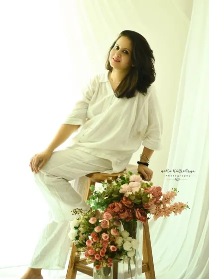 A moment of self-love. This simple, light-filled self-portrait in a comfortable white outfit captures a feeling of peace and contentment.
