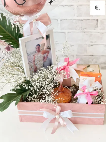 A closer look at the personalized birthday hamper for Kinman. The details matter, from the delicate ribbons and baby's breath to the custom photo frame, every element is chosen to make the recipient feel cherished.
