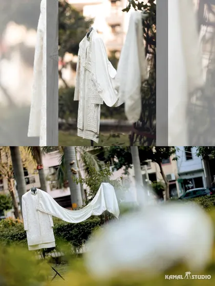An artistic shot of the groom's white sherwani, hanging in a garden before the ceremony.
