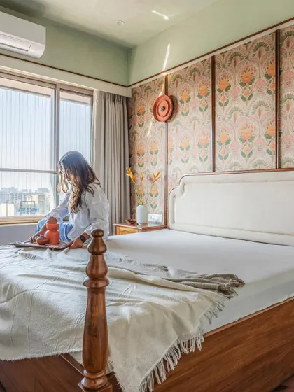 A bedroom should be a personal sanctuary. For this traditional home, we created a feature wall with floral wallpaper framed by wood battens, paired with a classic four-poster bed. The result is a cozy, textural, and timeless space that invites rest.