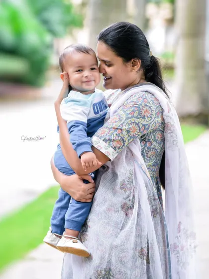 The pure happiness in this mother-son portrait is undeniable. The baby's smile as his mother holds him close is a precious moment captured forever.