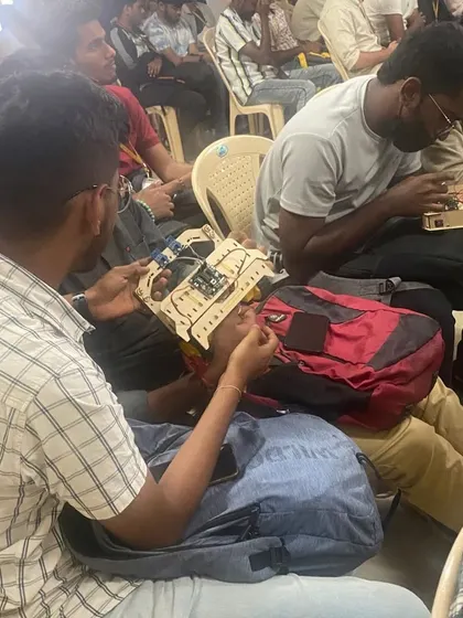 Students helping each other troubleshoot during a hands-on building session. This collaborative spirit is a key part of the learning process.