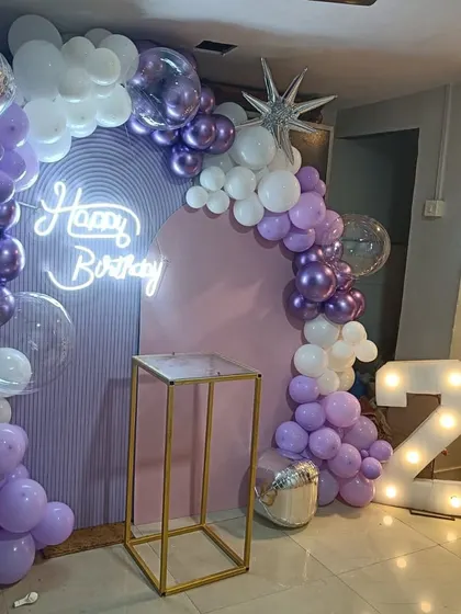 This photo shows the setup with a pedestal for the cake, demonstrating how the decor creates a perfect centerpiece.